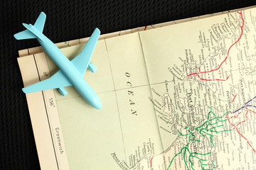 Fototapeta na wymiar The old map and blue color jet plane toy model represent the tourism and travel industry concept related idea.