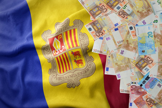 euro money banknotes on the waving national flag of andorra.
