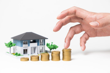 real estate and funds, hand holding a coin