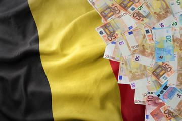 euro money banknotes on the waving national flag of belgium. © luzitanija