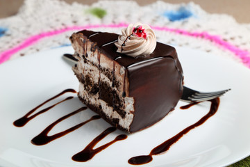 Chocolate cake or pastry in a white ceramic plate.