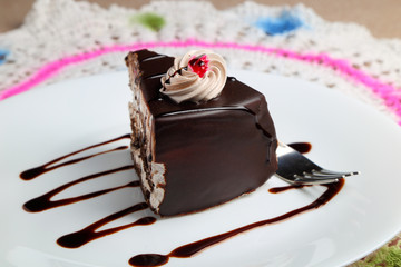 Chocolate cake or pastry in a white ceramic plate.