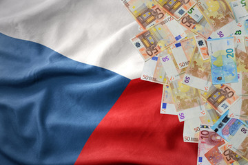 euro money banknotes on the waving national flag of czech republic.