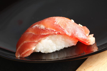 The japanese sushi on black color plate super macro shot represent the japanese food concept related idea.