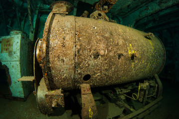 This heavy machinery is part of the shipwreck f the USS Kittiwake. The vessel was sunk to make an artificial reef and scuba and snorkel attraction. This heavy metal is now a habitat for marine life
