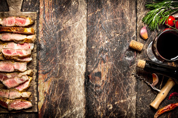 Meat grill. Pieces of pork grilled with spices and red wine. On the old wooden table.