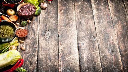 Organic Food. Vegetables and various bean seeds. On the old wooden table.