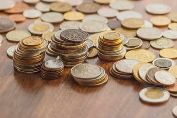 Different gold and silver collector's coins on the wooden table