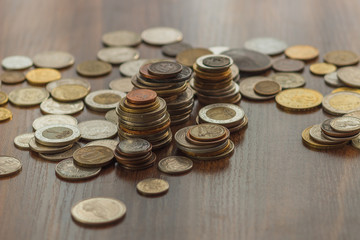 Different gold and silver collector's coins on the wooden table