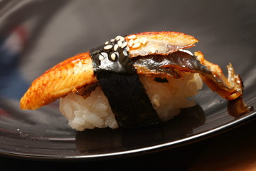 The japanese sushi on black color plate super macro shot represent the japanese food concept related idea.