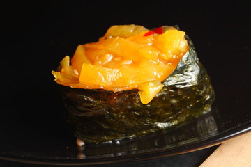 The japanese sushi on black color plate super macro shot represent the japanese food concept related idea.