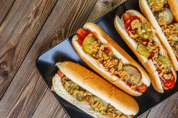 American hot dog with pickles,onions, ketchup and mustard