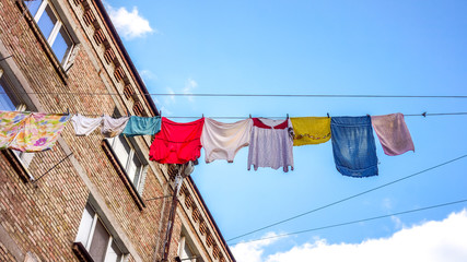 Underwear drying on the rope between old houses