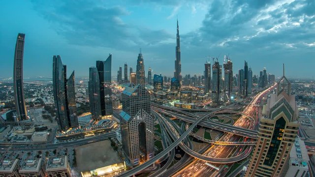 View on modern skyscrapers and busy evening highways day to night timelapse in luxury Dubai city, Dubai, United Arab Emirates