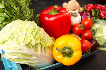Fresh organic homegrown vegetables in blue wooden box