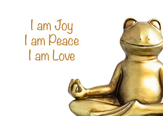 Smiling gold yoga frog meditating in lotus pose. Joy, peace, love quote. Isolated on white