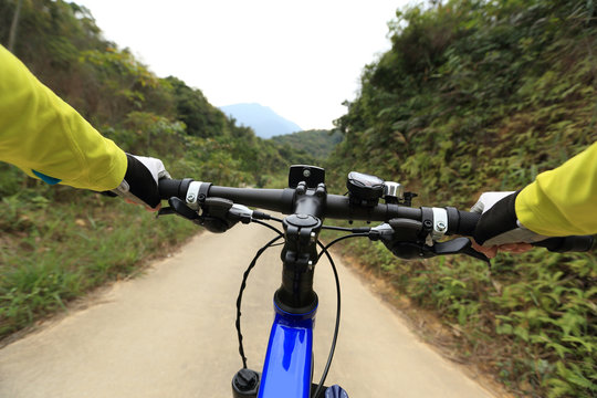 cyclist use smartphone for navigator when riding mountain bike on forest trail
