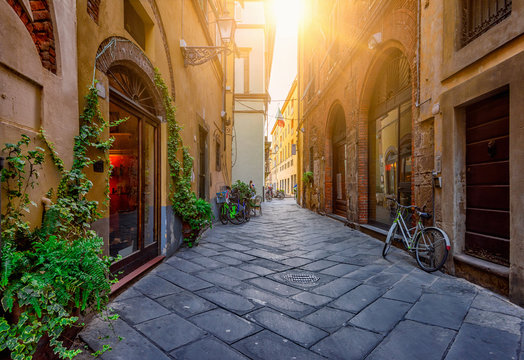 Fototapeta Narrow old cozy street in Lucca, Italy