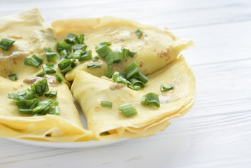 Fried puncakes with green onion on white background