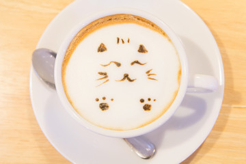 Cat latte on the table / hot coffee