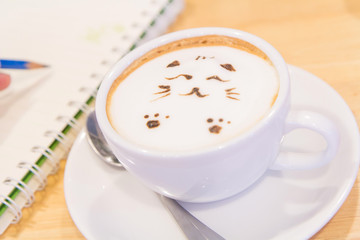 Cat latte on the table / hot coffee