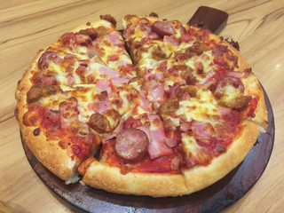 pizza on wooden tray close up