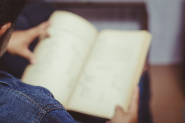 Fototapeta premium Young man reading a book