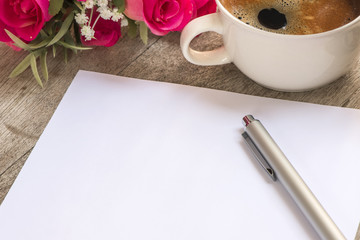 blank note and pen  with cup of coffee background