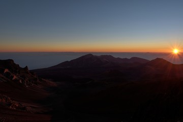 Sunrise breaks at Mount Haleakala, Maui