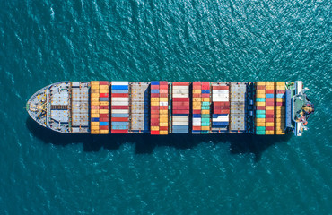 container ship in import export and business logistic.By crane ,Trade Port , Shipping.cargo to...