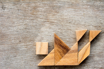 Wood tangram puzzle in human stumble and falling shape (Concept for business face the crisis)