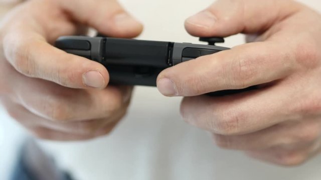 Video Gamer Holding A Controller And Playing Video Games