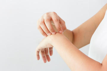 Women scratch the itch with hand / arm  itching / Concept with Healthcare And Medicine.