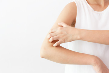 Women scratch the itch with hand / arm  itching / Concept with Healthcare And Medicine.