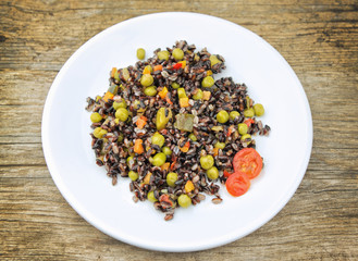 Veggie black rice on wooden table