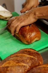Freshly baked bread to be cut into a restaurant kitchen. - 139347509