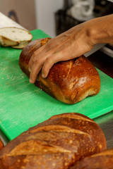 Freshly baked bread to be cut into a restaurant kitchen. - 139347570