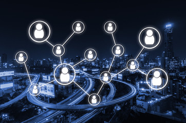 social media icon network connection concept on night city background, blue color tone effect.