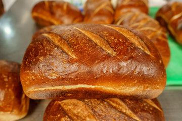 Freshly baked bread to be cut into a restaurant kitchen. - 139348318