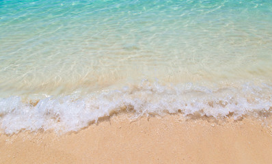 Fototapeta na wymiar Soft wave of the sea on the sandy beach at Thailand.