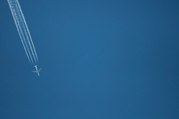 One plane fly on blue sky background