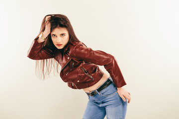 Rock chick in leather jacket, full length. Fashion portrait of elegant woman, studio shot © Andriy