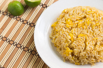 Asian fried rice with eggs on wooden background.