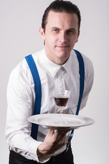 young waiter serving drink