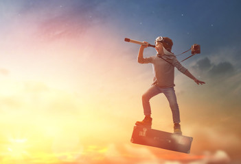 Child flying on a suitcase