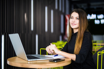 Happy smiling woman working with laptop in modern smart space hub