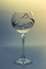 Splash water in a glass on a gray