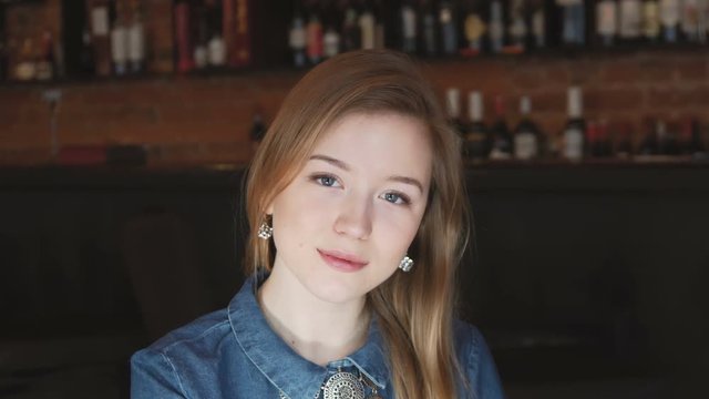 Beauty portrait, beautiful blonde young woman look and smile at camera while sitting on dating in cafe