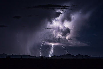 Fototapeta na wymiar Thunderstorm lightning bolts and cumulonimbus cloud