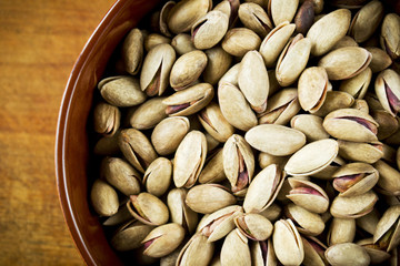 Pistachio nuts in bowl, top view